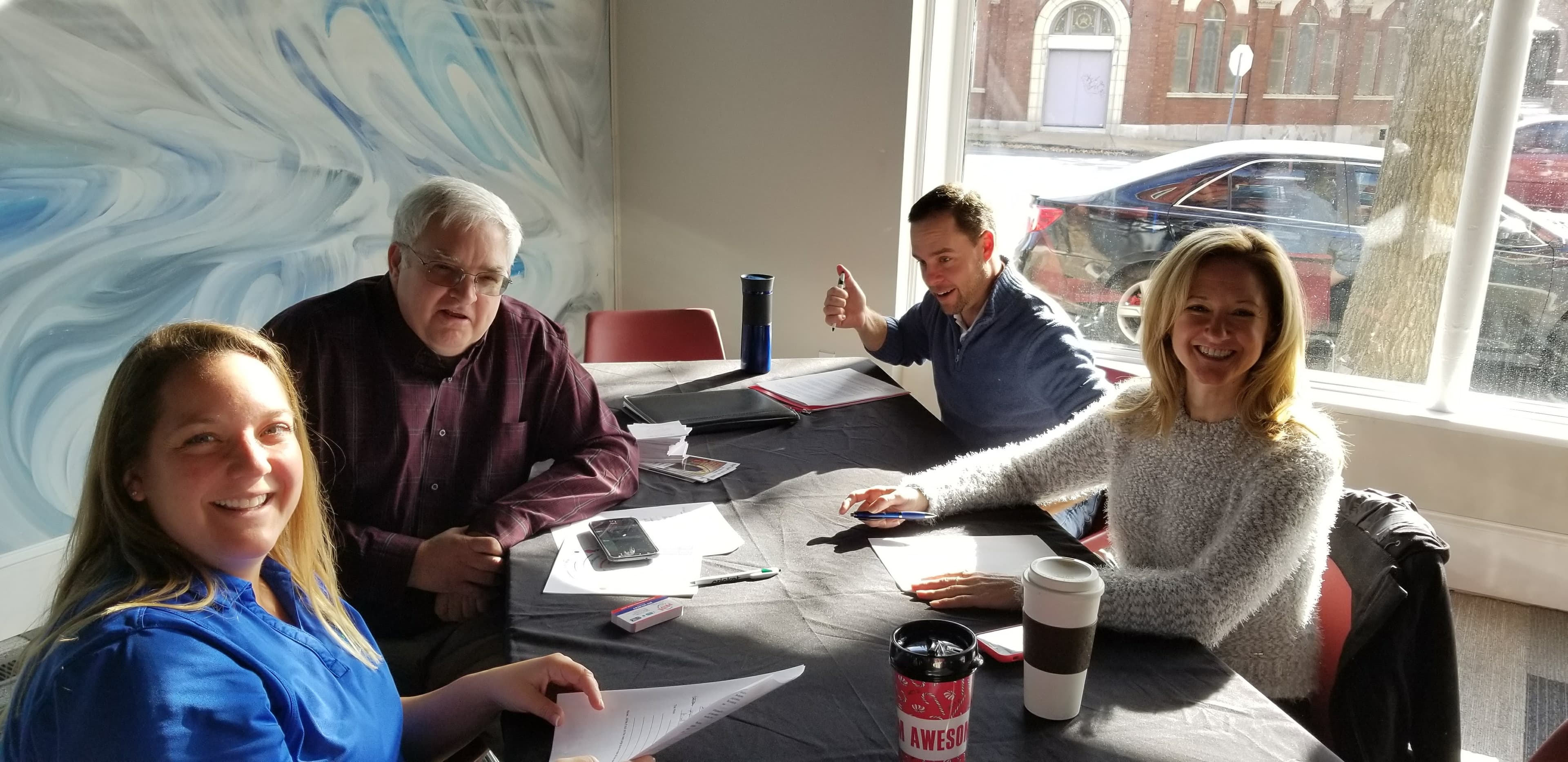 Four BusinessGPS members working around a table, St. Louis